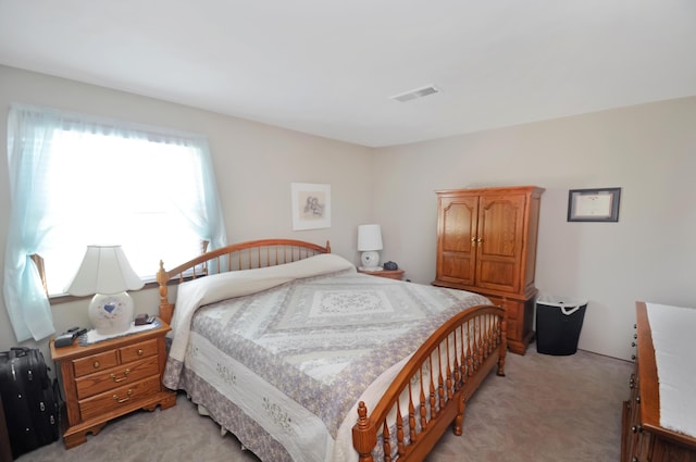 bedroom featuring light colored carpet