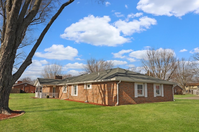 view of property exterior featuring a yard and covered porch