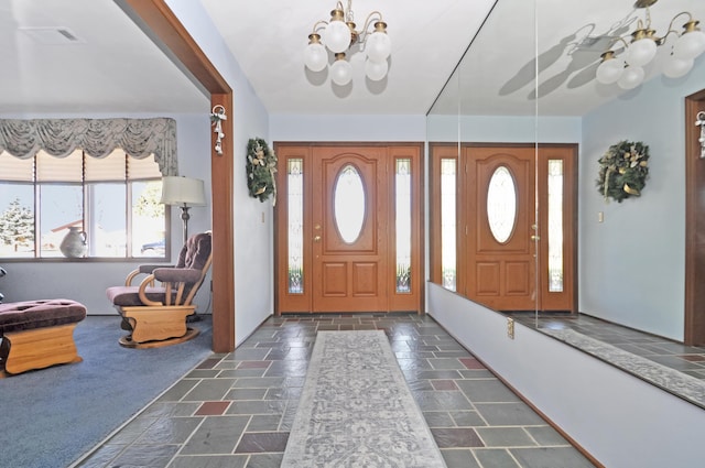 foyer entrance with a notable chandelier