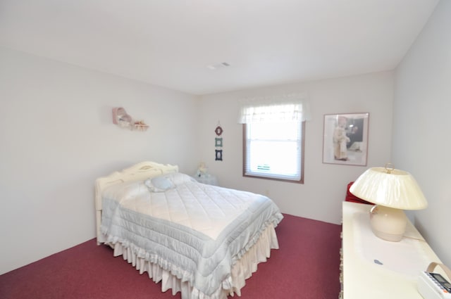 bedroom with dark colored carpet