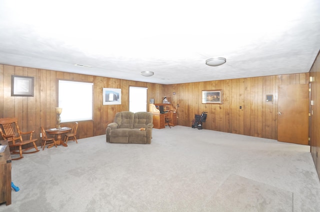 living area featuring wood walls and carpet flooring