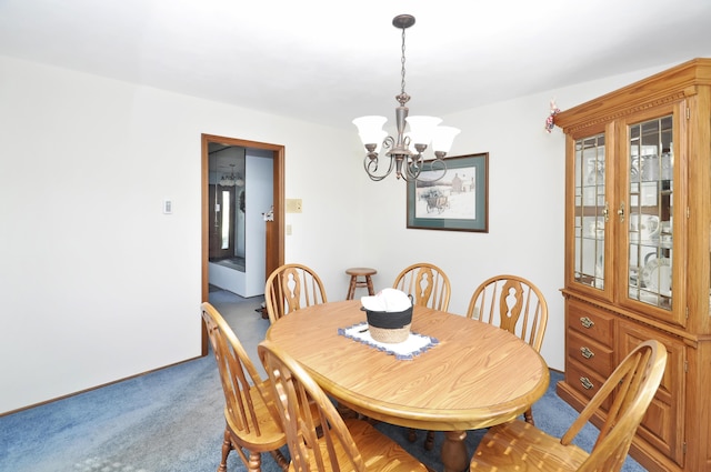 dining area with a notable chandelier and carpet floors