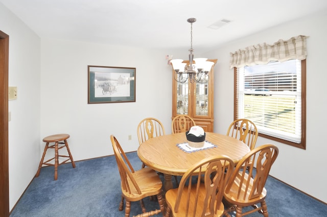 dining area featuring an inviting chandelier and dark carpet