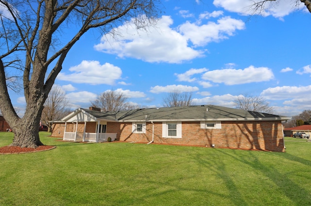 rear view of house with a lawn