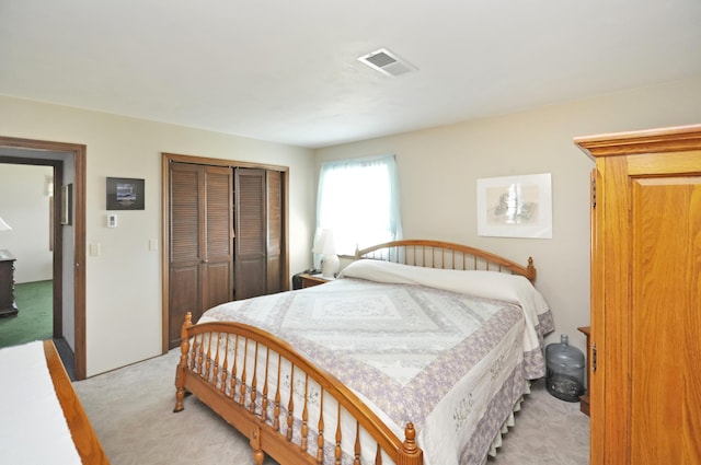 carpeted bedroom with a closet