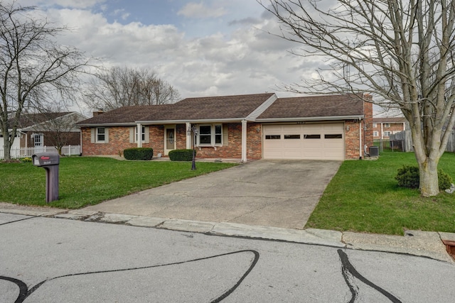 single story home featuring driveway, a front yard, a chimney, an attached garage, and brick siding