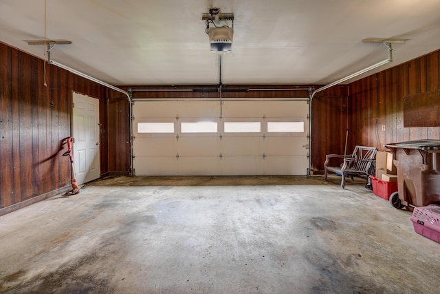 garage with wooden walls and a garage door opener