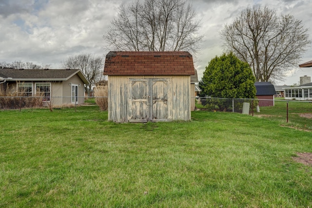 view of yard featuring a fenced backyard, a shed, and an outdoor structure