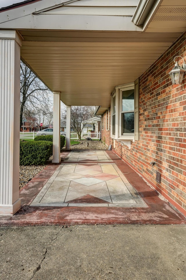 view of patio / terrace with a carport and fence