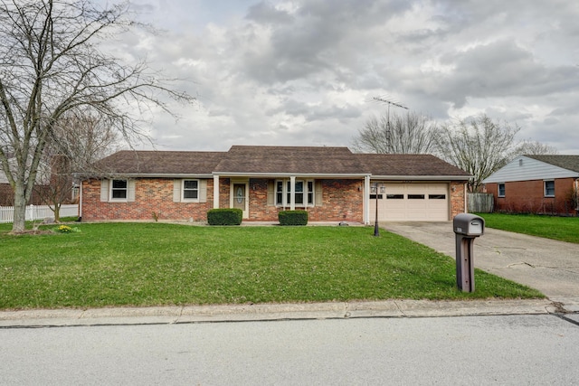 ranch-style home with brick siding, concrete driveway, a front lawn, and an attached garage