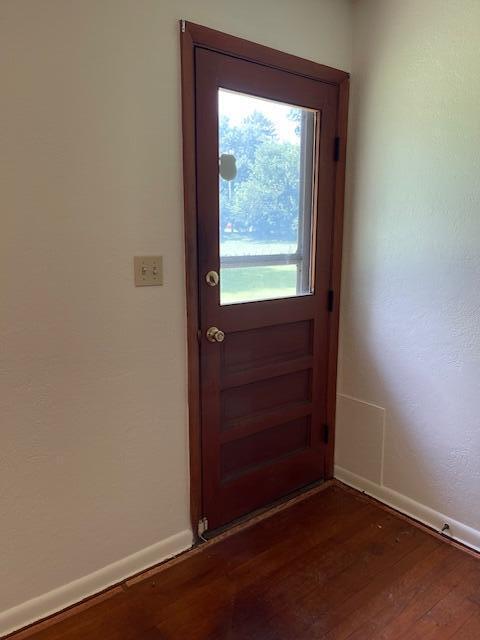 1401 E Home Rd, Springfield, OH 45503 - doorway to outside with dark wood-type flooring and baseboards