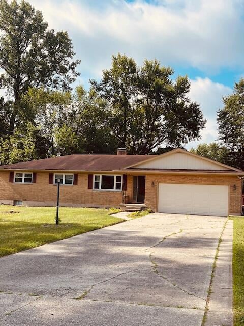 1401 E Home Rd, Springfield, OH 45503 - ranch-style house with driveway, an attached garage, and a front lawn