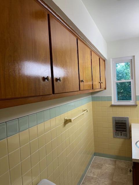 1401 E Home Rd, Springfield, OH 45503 - bathroom featuring tile walls, vanity, wainscoting, tile patterned floors, and heating unit