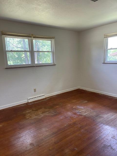 1401 E Home Rd, Springfield, OH 45503 - spare room featuring baseboards and hardwood / wood-style flooring