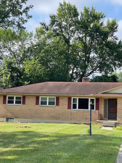 1401 E Home Rd, Springfield, OH 45503 - ranch-style home with brick siding, a front yard, and a chimney