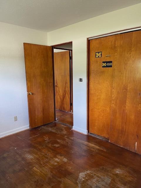 1401 E Home Rd, Springfield, OH 45503 - unfurnished bedroom featuring hardwood / wood-style flooring and baseboards