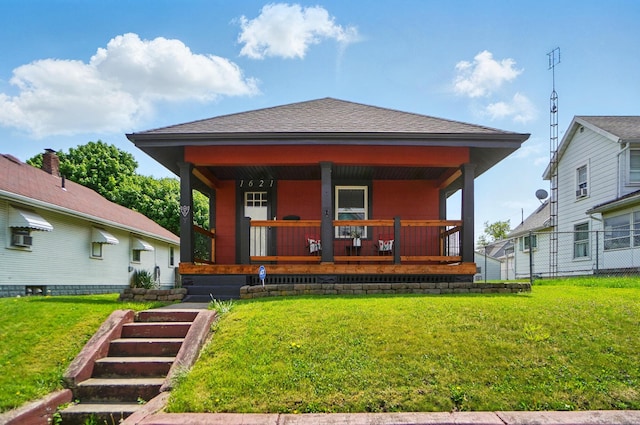 exterior space featuring a lawn, fence, covered porch, and a shingled roof