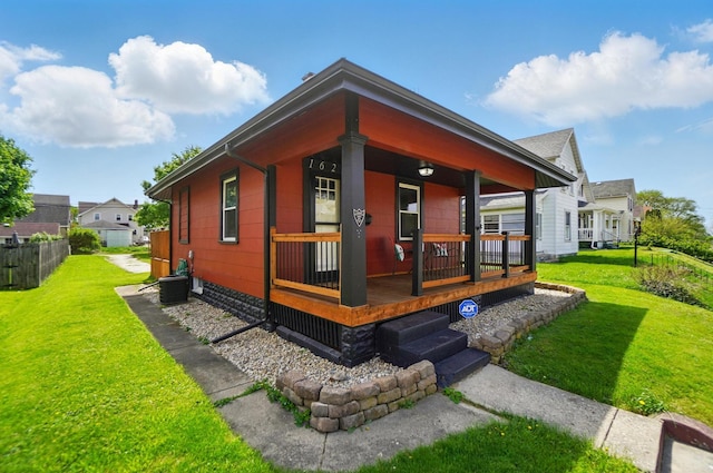 exterior space with a yard, fence, and covered porch