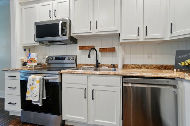 kitchen featuring a sink, appliances with stainless steel finishes, and white cabinetry