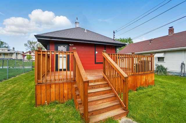 deck with fence, a yard, and stairway