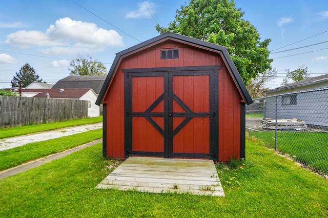 view of shed featuring fence