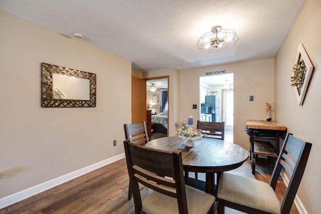 4212 Midfield St, Springfield, OH 45503 - dining room with dark wood-style floors, a textured ceiling, and a chandelier