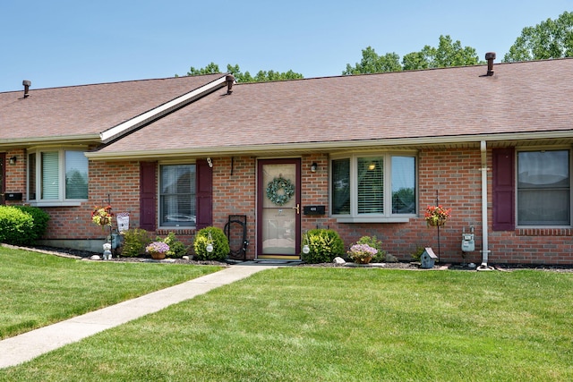 4212 Midfield St, Springfield, OH 45503 - view of front of house featuring roof with shingles, brick siding, and a front yard