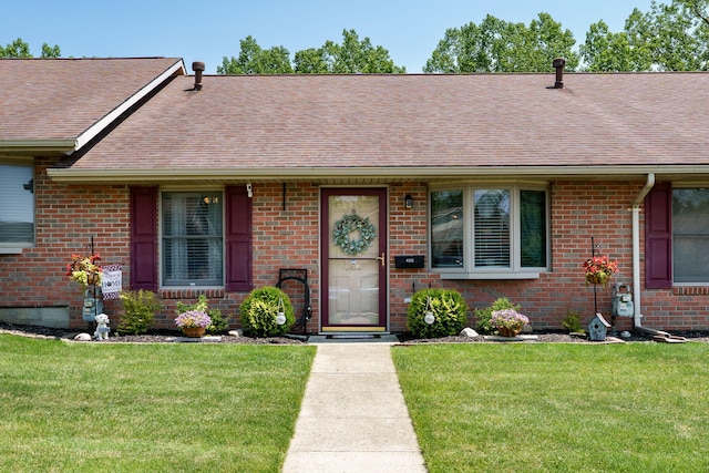 4212 Midfield St, Springfield, OH 45503 - ranch-style house with a shingled roof, a front lawn, and brick siding