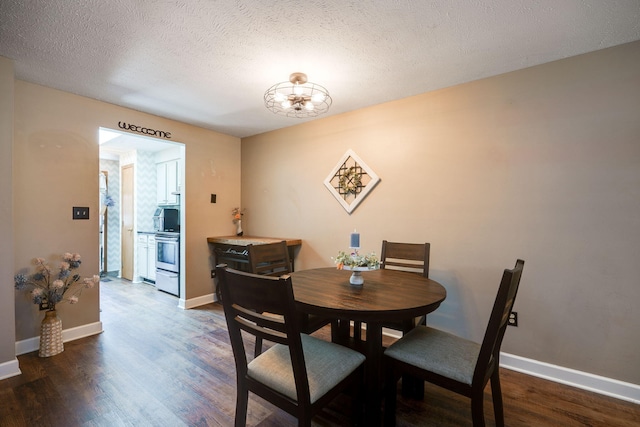 4212 Midfield St, Springfield, OH 45503 - dining room featuring dark wood finished floors, a chandelier, and a textured ceiling