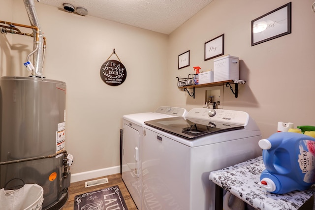 4212 Midfield St, Springfield, OH 45503 - washroom with water heater, wood finished floors, independent washer and dryer, and a textured ceiling