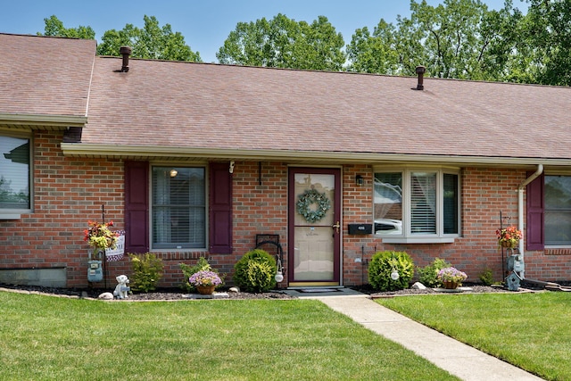 4212 Midfield St, Springfield, OH 45503 - ranch-style home with a shingled roof, brick siding, and a front lawn