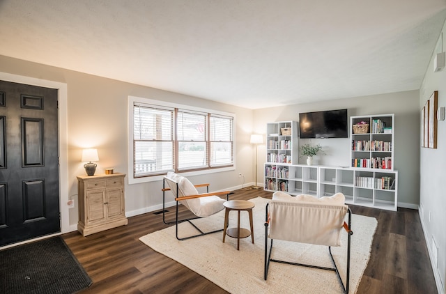 sitting room with dark wood-type flooring