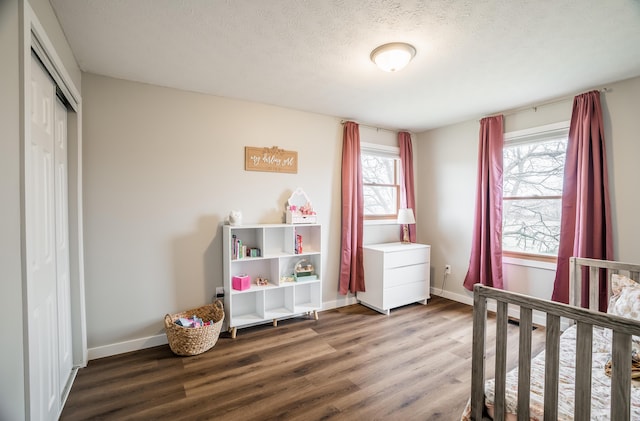 bedroom with hardwood / wood-style flooring, a textured ceiling, and a closet