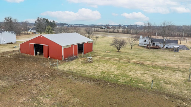 view of outbuilding featuring a lawn and a rural view