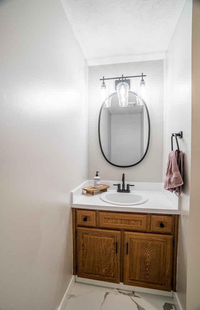 bathroom with vanity and a textured ceiling