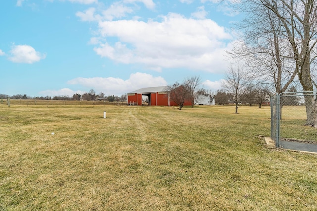 view of yard featuring an outdoor structure and a rural view