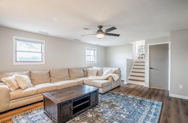 living room featuring dark hardwood / wood-style floors and ceiling fan