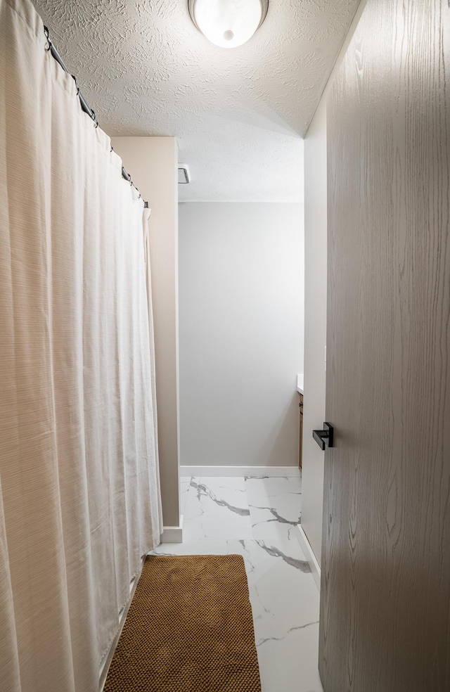 bathroom featuring a textured ceiling