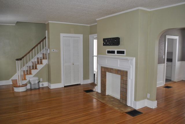 unfurnished living room with hardwood / wood-style floors and ornamental molding