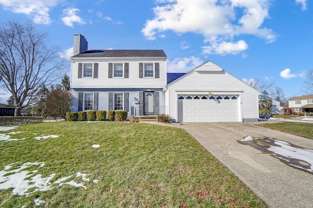 view of front of home featuring a garage and a front yard