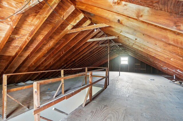 unfinished attic with an upstairs landing