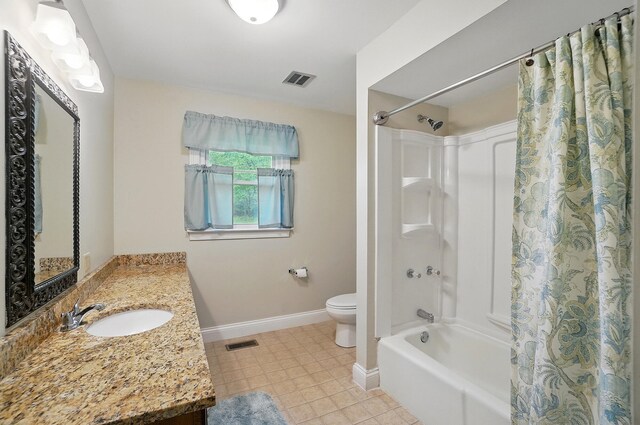 bathroom featuring baseboards, toilet, shower / bath combo with shower curtain, and vanity