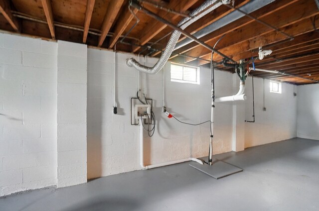 below grade area featuring healthy amount of natural light and concrete block wall
