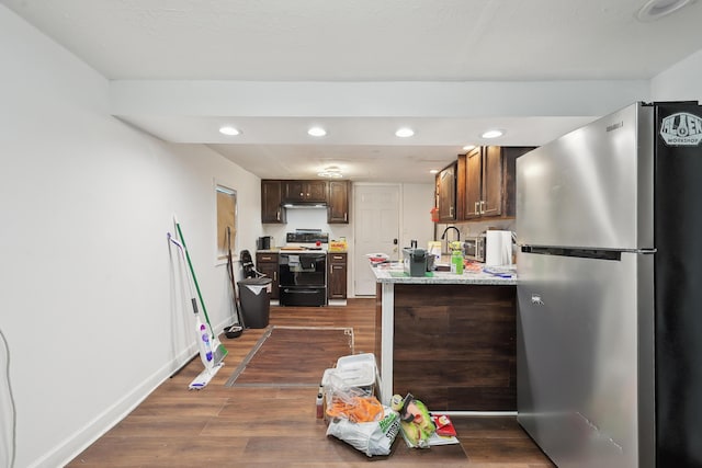 1566 Cora St, Springfield, OH 45503 - kitchen with freestanding refrigerator, black range with electric stovetop, light countertops, recessed lighting, and dark wood-style floors