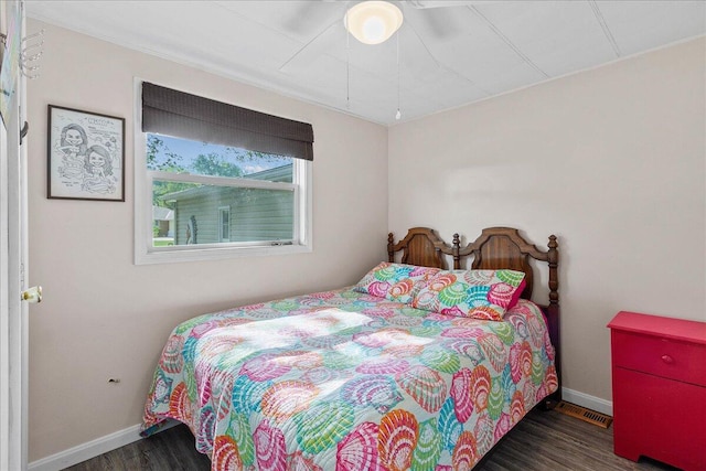 bedroom with dark wood-type flooring