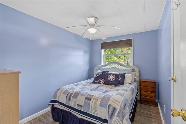 bedroom featuring hardwood / wood-style flooring and ceiling fan