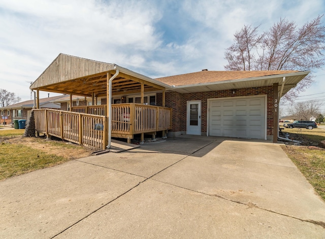 view of front of house featuring brick siding, a garage, driveway, and roof with shingles