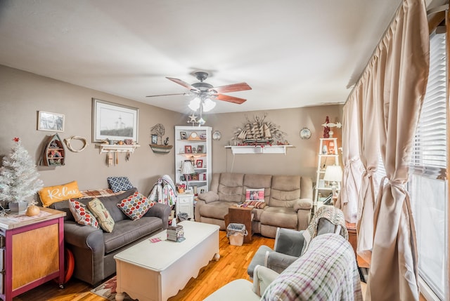 living area with light wood-style floors and ceiling fan