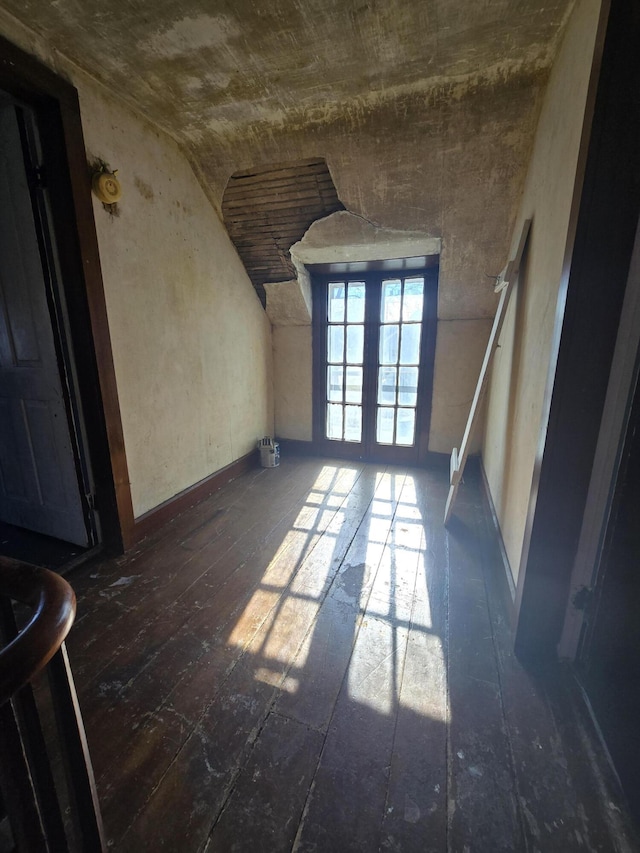 spare room with dark hardwood / wood-style floors and french doors