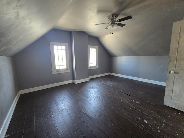 bonus room with dark hardwood / wood-style flooring, lofted ceiling, and ceiling fan